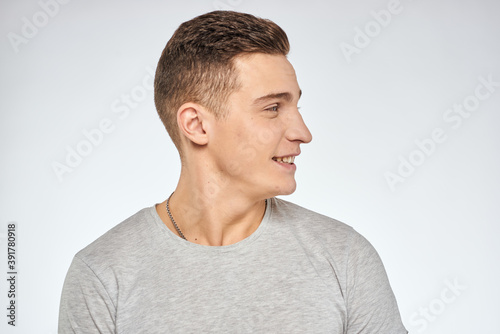 Handsome man in gray t-shirt cropped view of emotion Studio Model