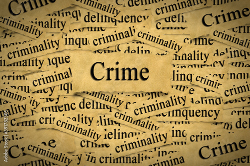 Abstract background from pieces of aged paper with the word crime and related words.