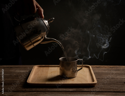 Pour the hot water of the french press tea into a glass. photo