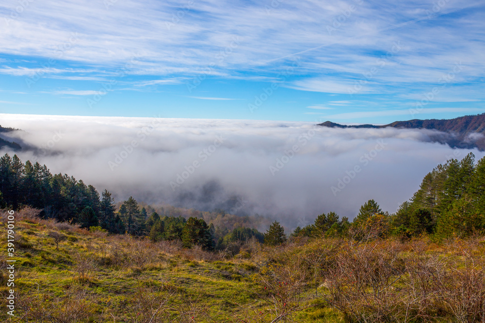 Autumn mountain landscape with low clouds, province of Genoa, Ligurian Alps, Italy.