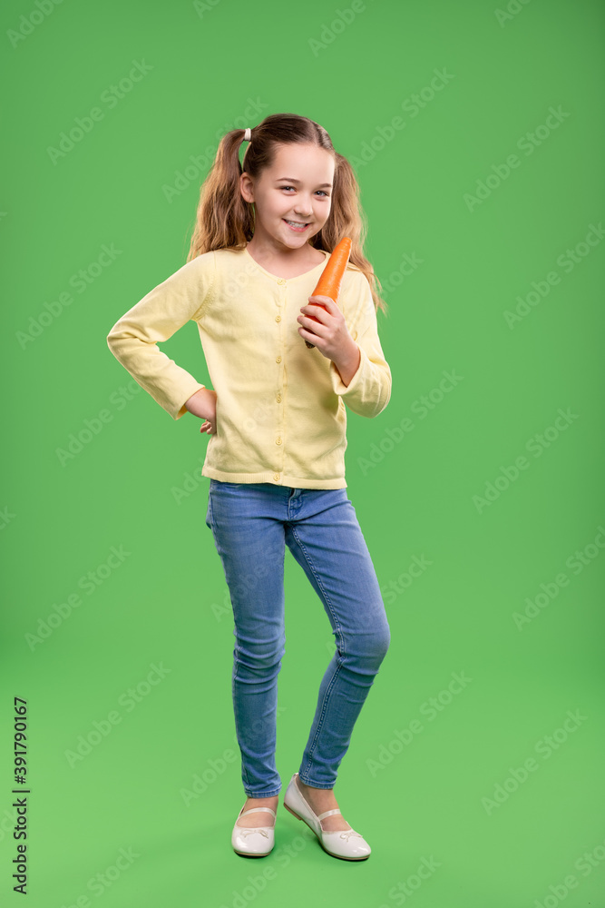 Happy girl with healthy carrot Happy girl with healthy carrot