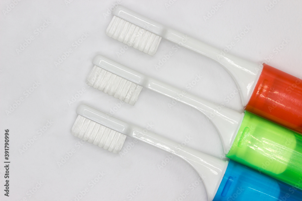 Colourful travel toothbrushes on a white background Colourful travel toothbrushes on a white background