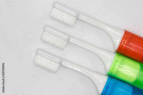 Colourful travel toothbrushes on a white background