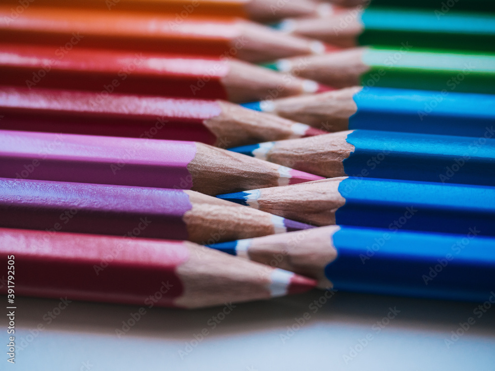 Color pencils on white background. Close up. School concept. Warm and cold colors Color pencils on white background. Close up. School concept. Warm and cold colors