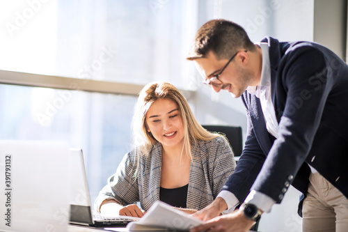 Tableau sur toile Man manager and woman data analyst working with together in a modern office