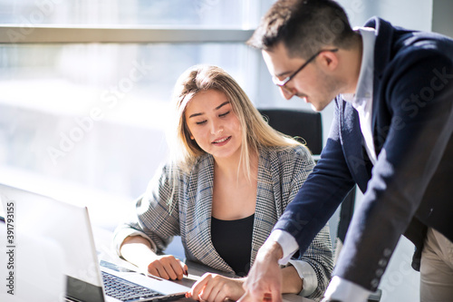 Wallpaper Mural Man manager and woman data analyst working with together in a modern office Torontodigital.ca