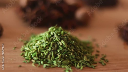 spices and herbs on kitchen or wooden table,Colorful spices and herbs for cooking with rotation teblet, Jaiphal, Star Anise, Chakri fool, Cardamom, Elaichi, Saunf,background rotating,