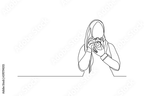 Continuous line drawing of professional woman muslim hijab photographer take picture use camera. One line art concept of photography. Vector illustration
