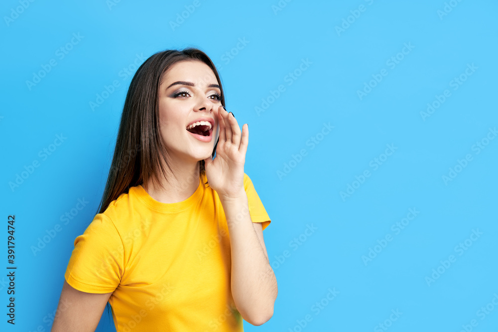 Young beautiful woman shouting and screaming loud to side with copy space Young beautiful woman shouting and screaming loud to side with copy space