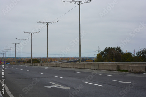 Gray long wide roads, highways of the city of Kamianske. An industrial landscape with an intense life and work.