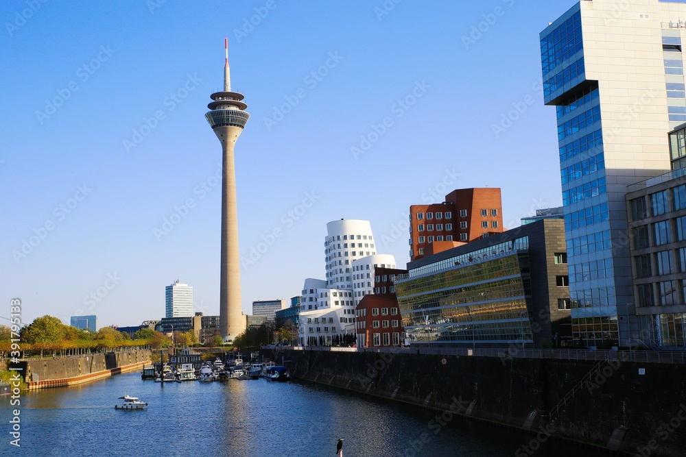 Dusseldorf (Medienhafen), Germany - November 7. 2020: View over river on television tower,  buildings with modern futuristic architecture design