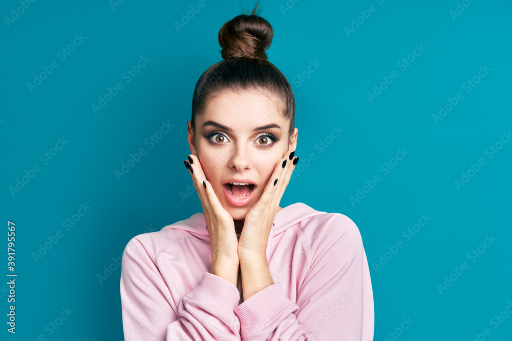 Portrait of surprised happy woman over blue backround. Wow concept Portrait of surprised happy woman over blue backround. Wow concept