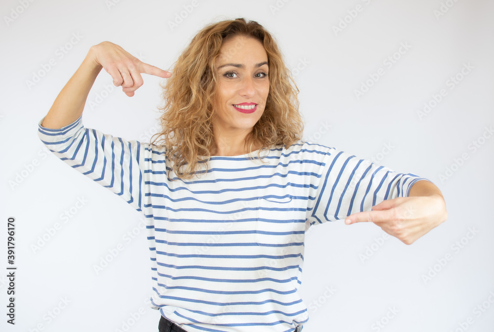 Beautiful curly hair young woman wearing casual t-shirt over isolated background pointing fingers to camera with happy and funny face. Good energy and vibes. Beautiful curly hair young woman wearing casual t-shirt over isolated background pointing fingers to camera with happy and funny face. Good energy and vibes.