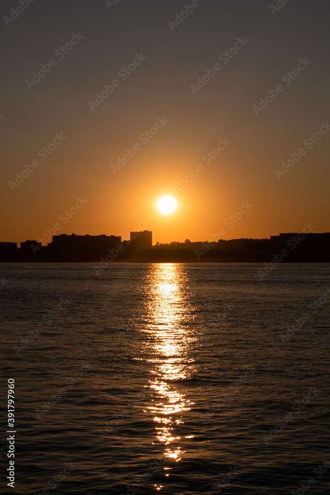 Sunset over a Silhouette of the Weehawken New Jersey Skyline along the Hudson River Sunset over a Silhouette of the Weehawken New Jersey Skyline along the Hudson River