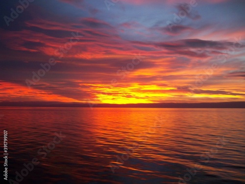 Beautiful sunrise at the high sea with a different colour in the sky © Prakash