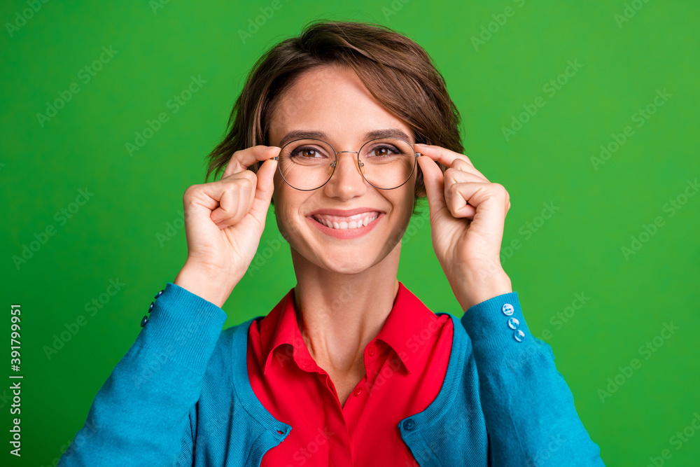 Photo of young cheerful girl happy positive smile hands touch glasses isolated over vibrant green color background