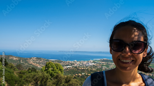 Nice girl smiling and posing in front of the Golfe of Saint Tropez