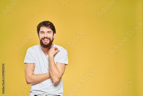 Bearded man in white t-shirt emotions close-up fun yellow background © SHOTPRIME STUDIO