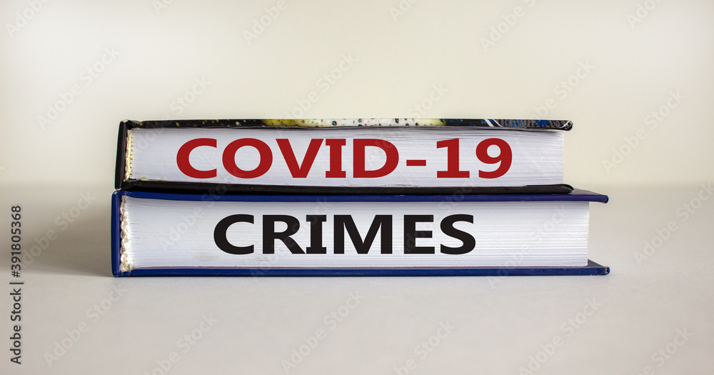 Concept words 'COVID-19 crimes' on books on a beautiful white background. Copy space. Business and covid-19 pandemic concept.