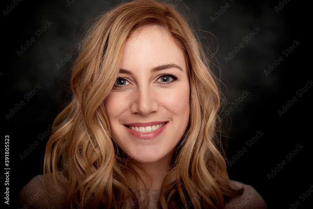 Portrait of a young blonde woman on a dark background. Portrait of a young blonde woman on a dark background.