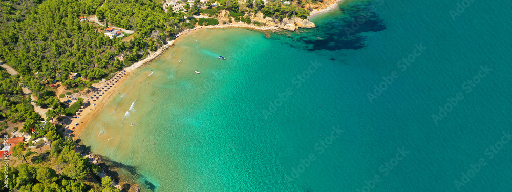 Aerial ultra wide panoramic view of tropical paradise rocky bay visited by sailboats and yachts in Caribbean exotic destination island