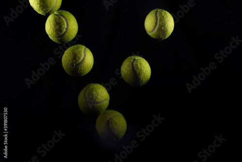 Movement or bounce of tennis ball isolated on black background.. © Vatcharachai