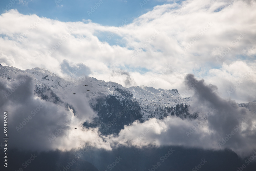 Snowy mountain Untersberg with clouds, snow and blue sky, Austria