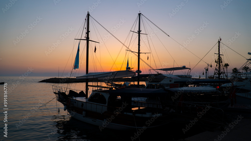 Tourist boats in the marina at sunset