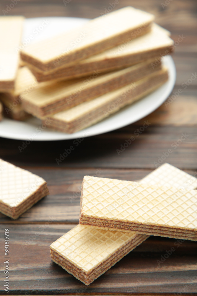 Chocolate wafers on plate on brown background Chocolate wafers on plate on brown background