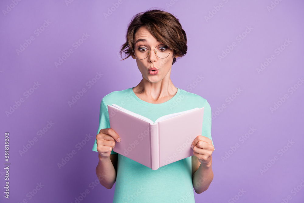 Photo of cute impressed short brown hairdo lady read copybook wear spectacles blue t-shirt isolated on violet background Photo of cute impressed short brown hairdo lady read copybook wear spectacles blue t-shirt isolated on violet background