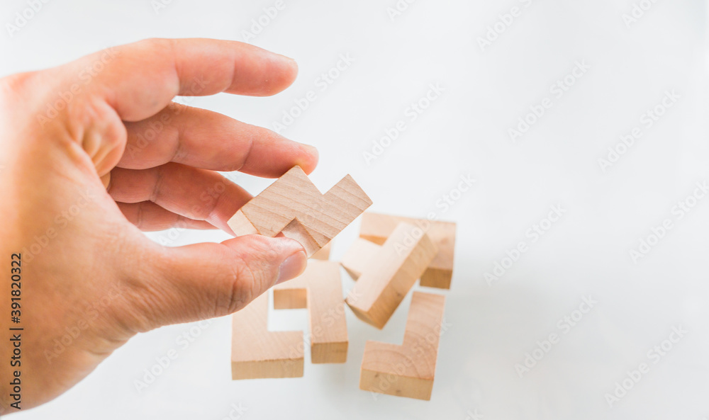 Wooden square block cube puzzle. Isolated on white background. Concept of complex and smart logical thinking. Slightly defocused and close up shot Wooden square block cube puzzle. Isolated on white background. Concept of complex and smart logical thinking. Slightly defocused and close up shot