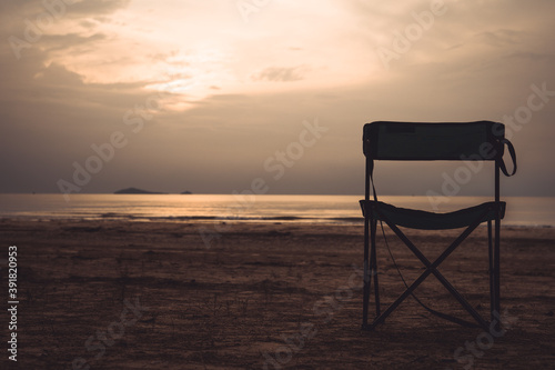 silhouette landscape beach chair and twilight sky with sunrise in summer