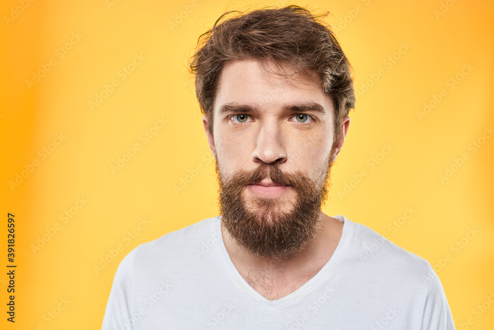 emotional bearded man in t-shirt cropped view yellow background studio emotional bearded man in t-shirt cropped view yellow background studio
