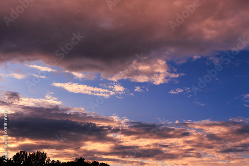 Sky with some dramatic clouds and vibrant colors at golden hour