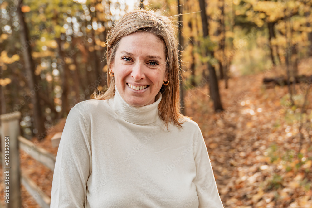 Mature woman on autumn leaves feeling great Mature woman on autumn leaves feeling great