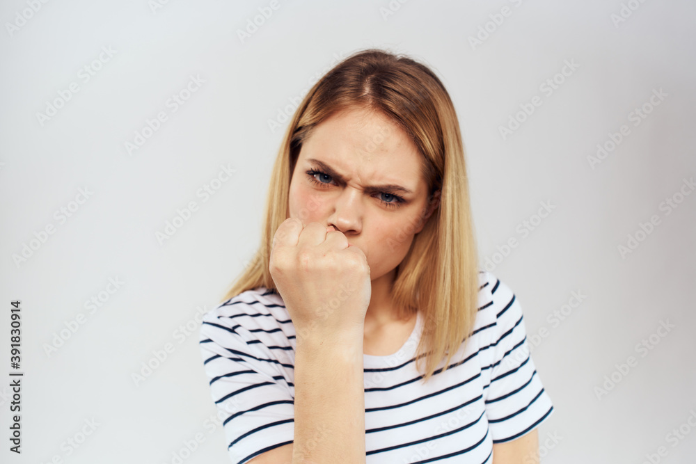 emotional woman in striped t-shirt gesture with hands lifestyle light background emotional woman in striped t-shirt gesture with hands lifestyle light background