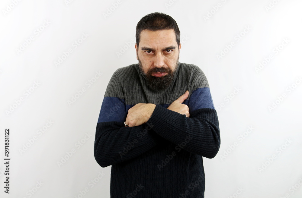 Young bearded man in casual turtleneck sweater on isolated white background, crosses his arms with chilled expression. Winter concept Young bearded man in casual turtleneck sweater on isolated white background, crosses his arms with chilled expression. Winter concept