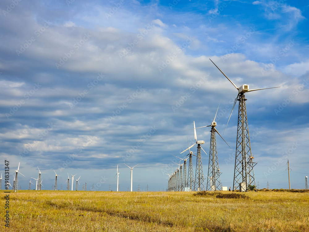 windmills for generating electricity on a Sunny summer day. windmills for generating electricity on a Sunny summer day.