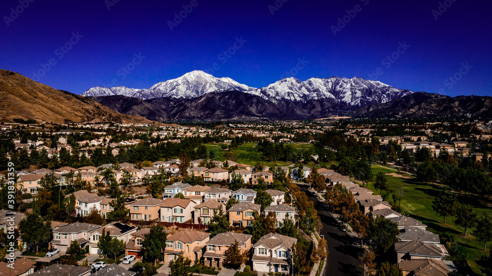 Aerial view of snow covered San Bernardino Peak in the San Bernardino mountains towering over the Yucaipa Valley, California on an clear, Autumn day