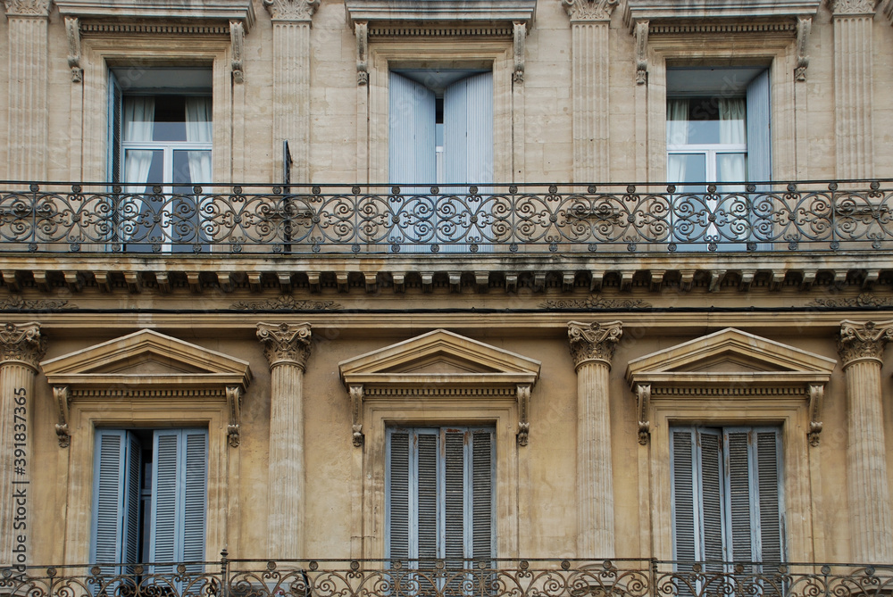 Typical French facade with balconies and shutters in south France Typical French facade with balconies and shutters in south France