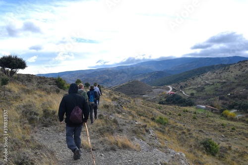 Hikers with backpacks on a mountain walk in the Cidacos Valley.
