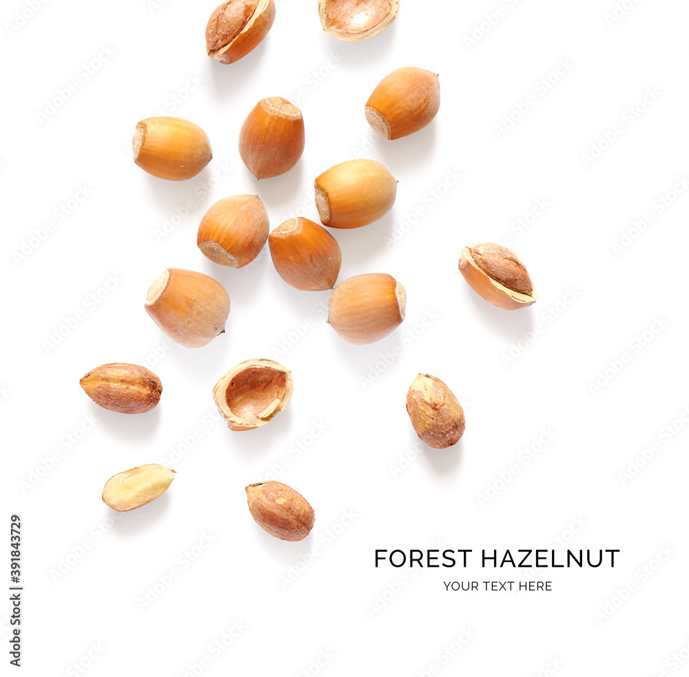 Creative layout made of forest hazelnut on the white background. Flat lay. Food concept. Macro concept. Creative layout made of forest hazelnut on the white background. Flat lay. Food concept. Macro concept.