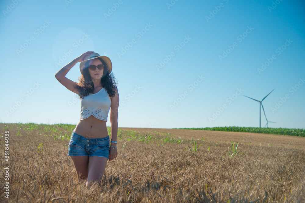 A girl in shorts and a hat in the grain A girl in shorts and a hat in the grain