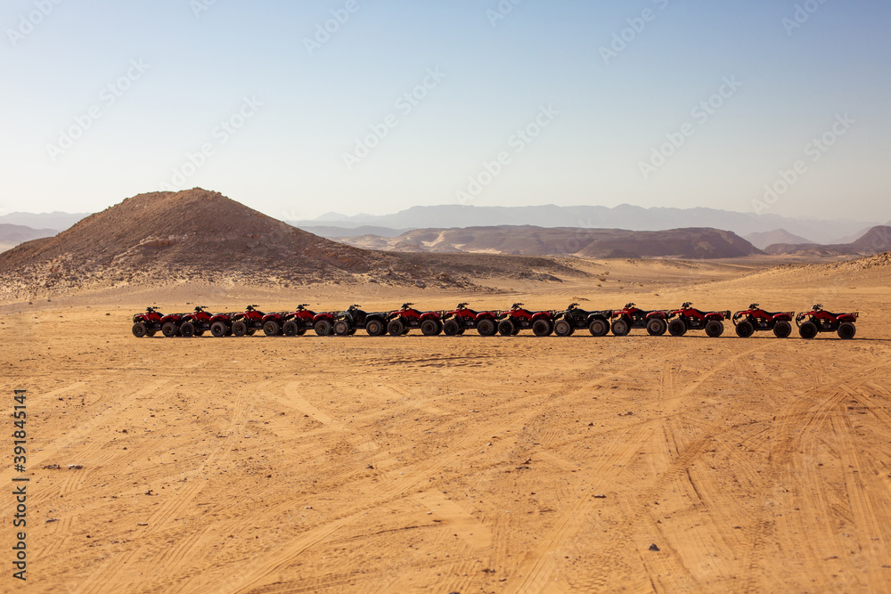 Red quad Cycle at the Sahara Desert. Extreme entertainment.
