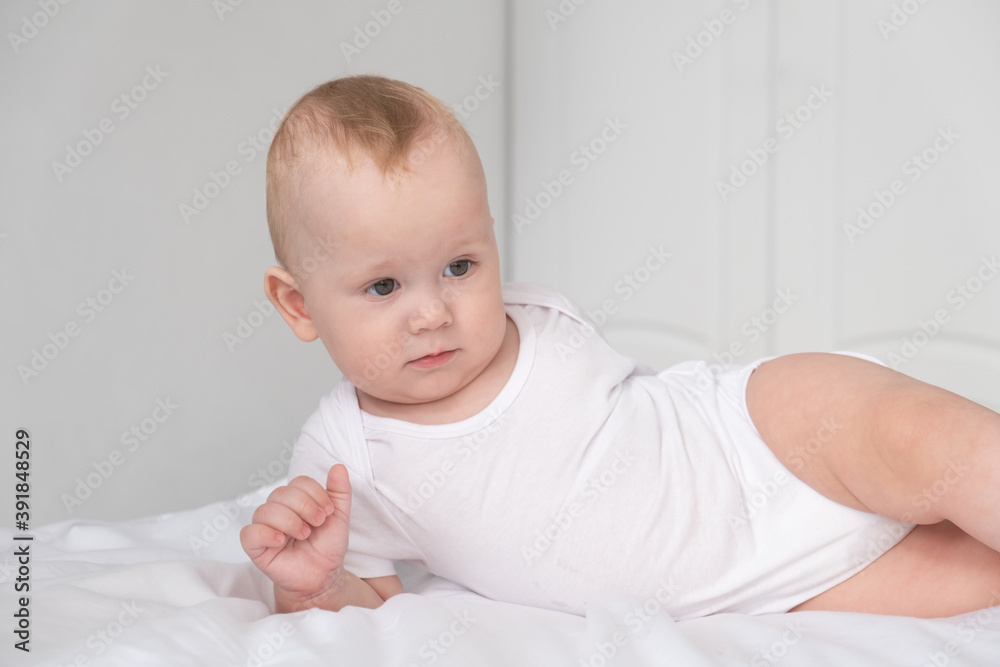 funny baby boy smiling in white bedroom at home. funny baby boy smiling in white bedroom at home.