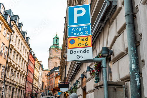 STOCKHOLM, SWEDEN - JANUARY, 2020: Swedish car parking road sign with parking rules in the background of city streets and buildings