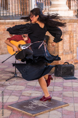 Photography Stock photo of a flamenco dancer dancing and feeling flamenco with and unrecognizable guitarist behind
