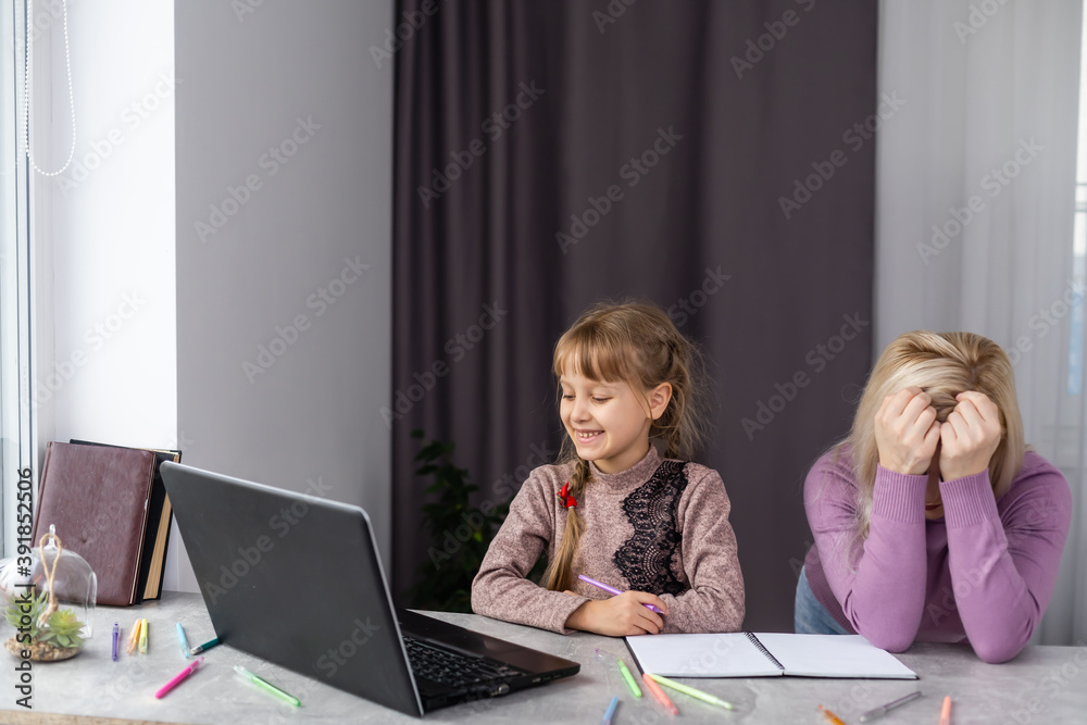Portrait of sad female with little schoolgirl doing homewor