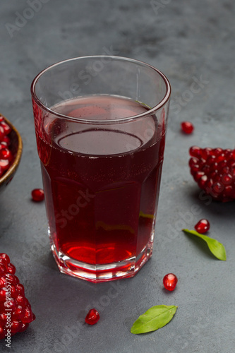 Pomegranate juice in bottle and pomegranate fruit section