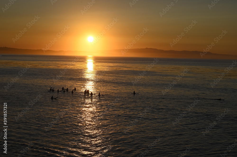 sunrise surfers on ocean sunrise surfers on ocean